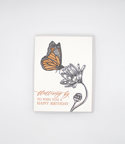 Letterpress birthday card with a butterfly and flower that says " Fluttering by to wish you a happy birthday" by Rust Belt Love 