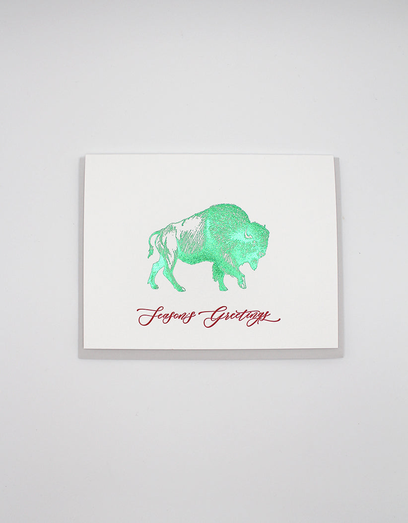 Green foil buffalo holiday card that reads "Season's Greetings" from Rust Belt Love