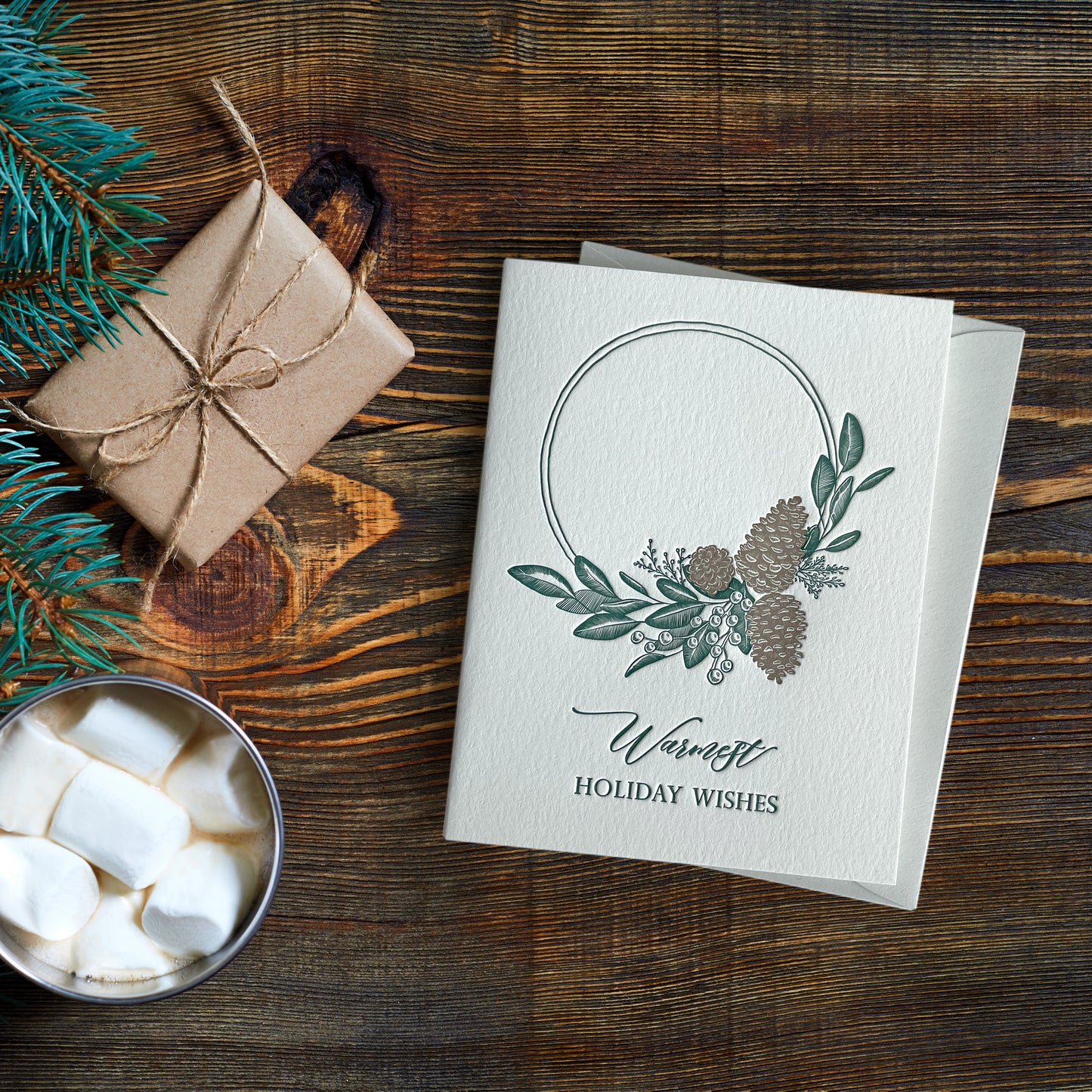 Letterpress holiday card with pinecones and greenery that says "Warmest holiday wishes" by Rust Belt Love