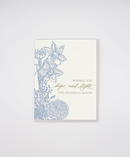 Letterpress holiday greeting card with florals that reads "Wishing you hope and light this Hanakkah season" by Rust Belt Love