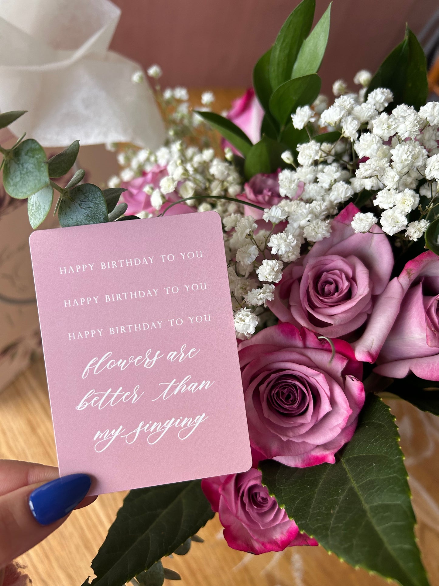 Styleshot of pink floral minicard in a bouquet of flowers, that reads "Happy birthday to you happy birthday to you happy birthday to you flowers are better than my singing". By Rust Belt Love