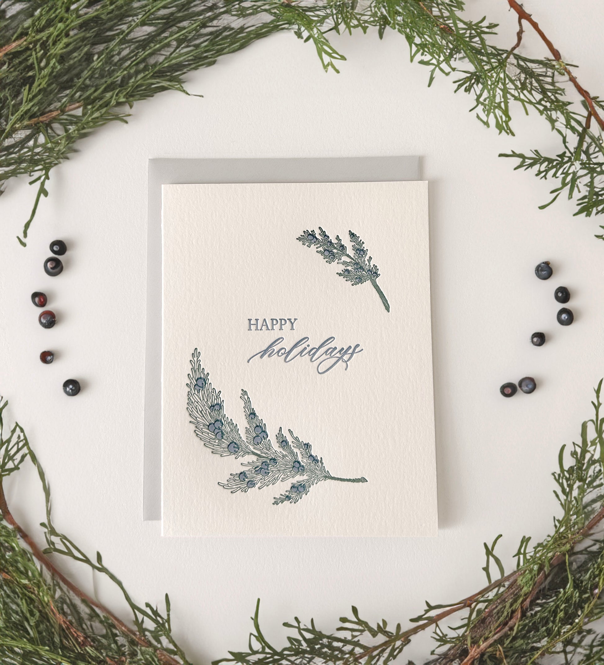 Letterpress holiday card with greenery that says "Happy Holidays" by Rust Belt Love