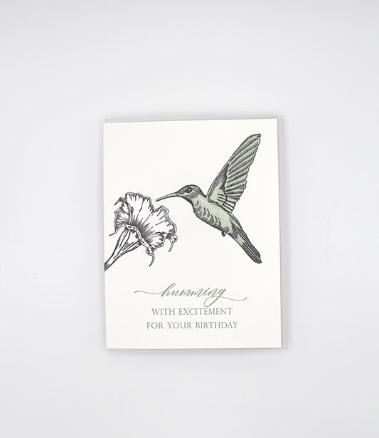 Letterpress birthday card with a flower and hummingbird that reads "Humming with excitement for your birthday" by Rust Belt Love