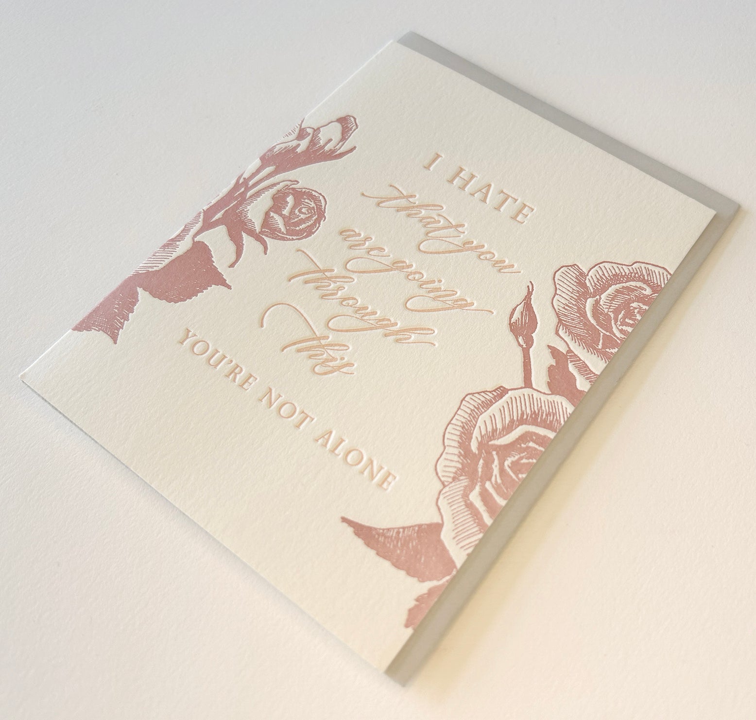 Letterpress sympathy card with florals that says "I hate that you are going through this, you're not alone" by Rust Belt Love