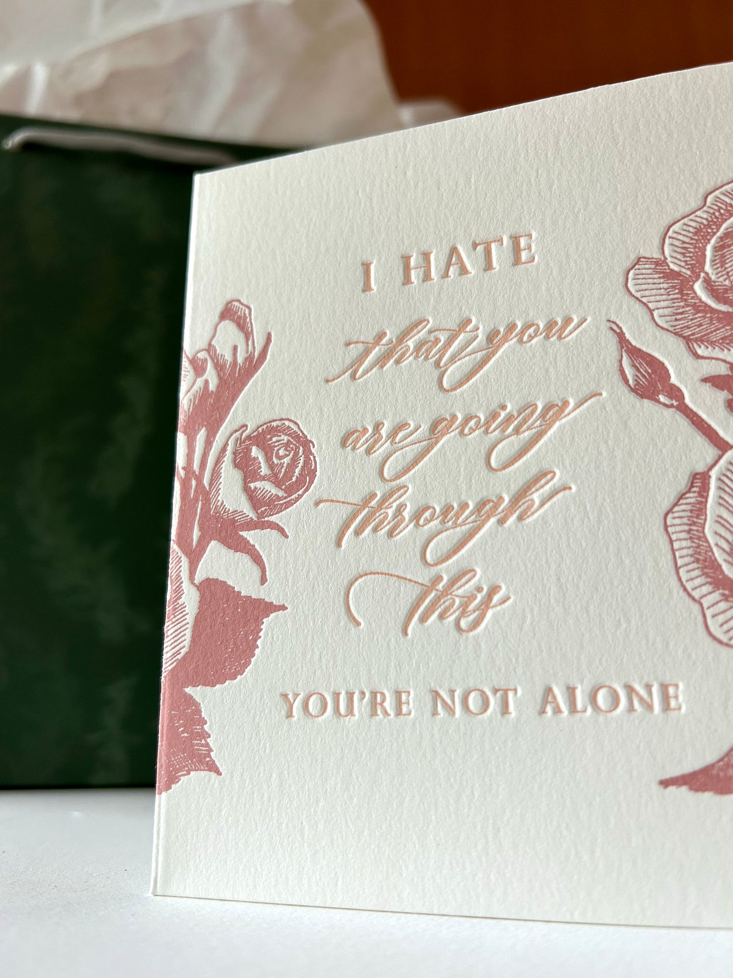 Letterpress sympathy card with florals that says "I hate that you are going through this, you're not alone" by Rust Belt Love