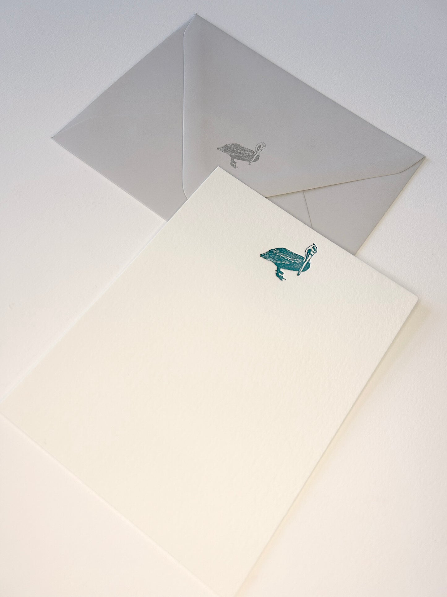 Letterpress flat note card with a teal pelican by Rust Belt Love