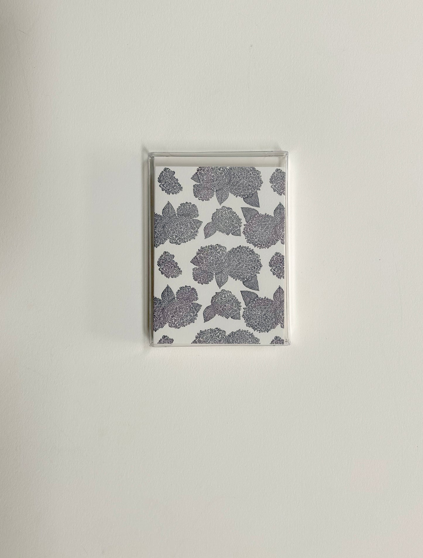 Purple hydrangea patterned small card by Rust Belt Love , shown in it's packaging of a clear plastic box