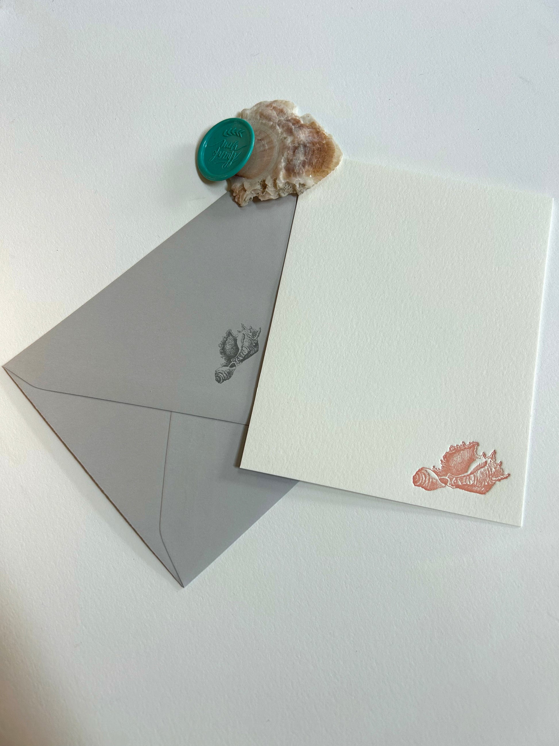 A style shot of Rust Belt Love's seashell letterpress flat note card with matching envelope