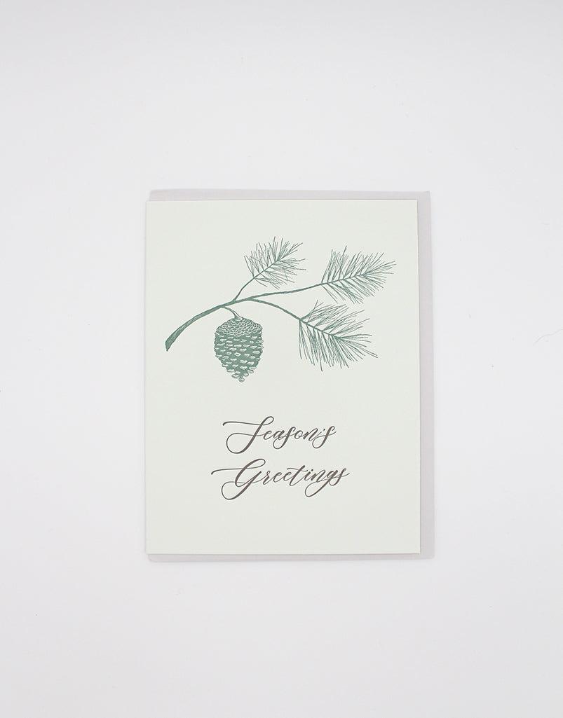 Green letterpress holiday card with branch and pinecone that reads "Season's Greetings" by Rust Belt Love