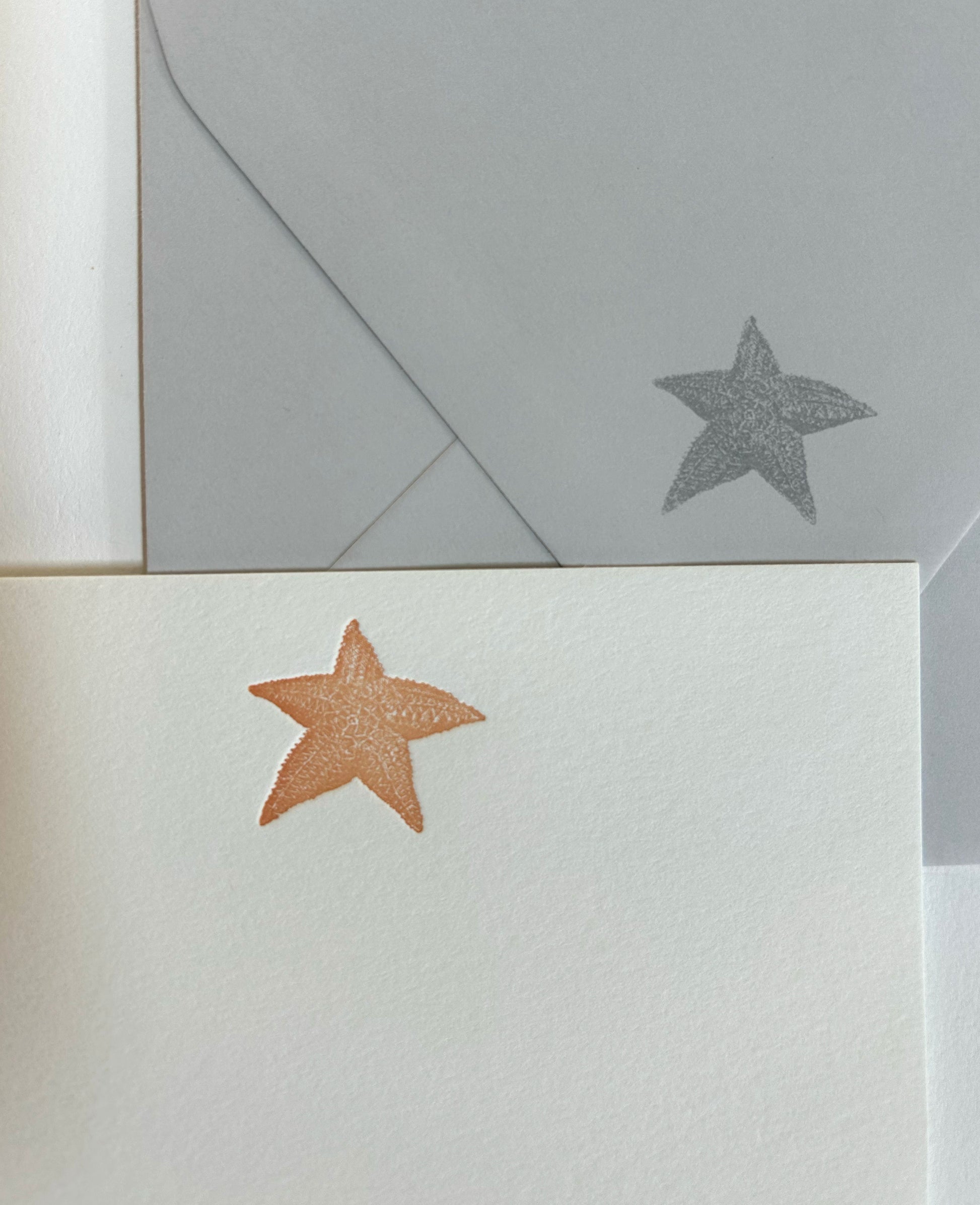 Letterpress flat note card with an orange starfish by Rust Belt Love