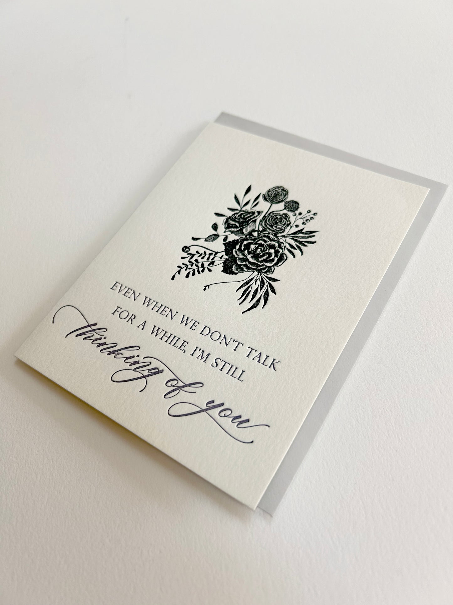 Letterpress friendship card with black florals that reads "Even when we don't talk for a while, I'm still thinking of you" from Rust Belt Love