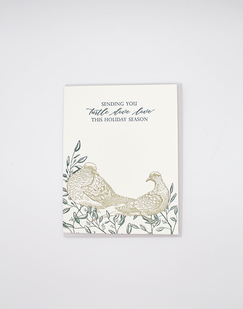 Letterpress holiday card with greenery and two doves that says "sending you turtle dove love this holiday season" by Rust Belt Love