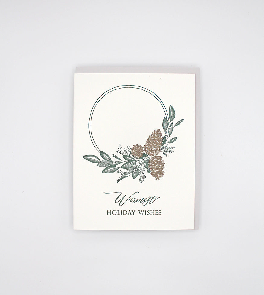 Letterpress holiday card with pinecones and greenery that says "Warmest holiday wishes" by Rust Belt Love