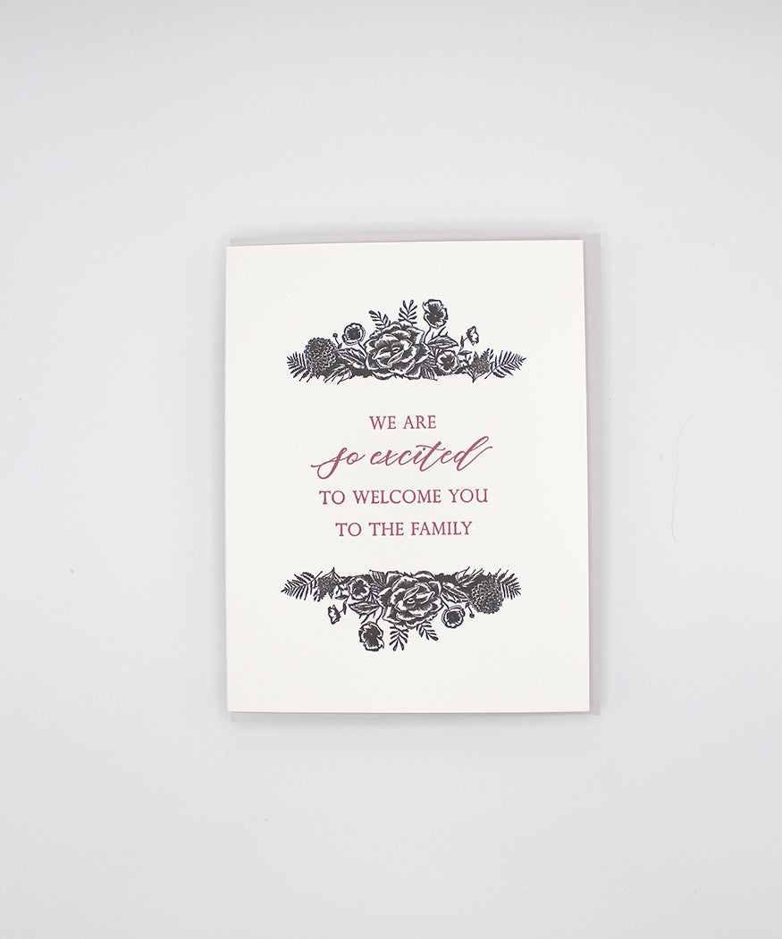 Letterpress wedding card with black florals that reads "We are so excited to welcome you to the family" by Rust Belt Love